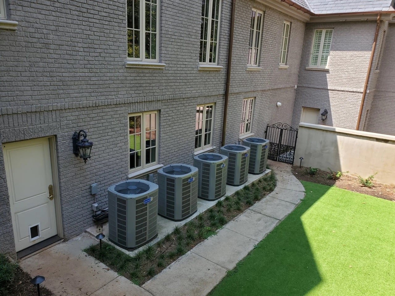 AC units lined up on outside of home